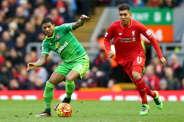 Patrick van Aanholt of Sunderland is watched by Roberto Firmino of Liverpool