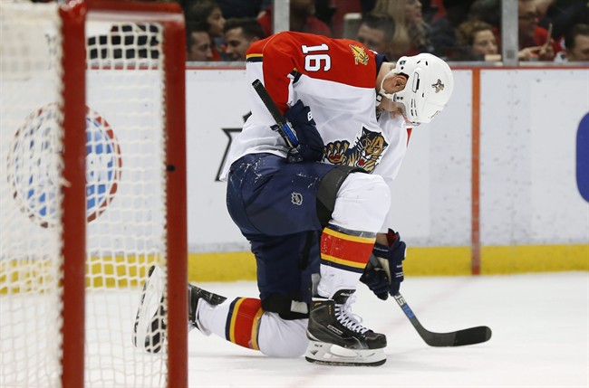 Florida Panthers center Aleksander Barkov takes a knee after being checked against the Detroit Red Wings in the second period of an NHL hockey game Monday Feb. 8 2016 in Detroit