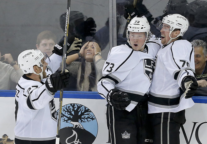 Los Angeles Kings left wing Tanner Pearson celebrates with center Tyler Toffoli and defenseman Alec Martinez after scoring the game-winning goal against the New York Rangers in overtime of an NHL hockey game Friday Feb. 12 2016 in New Y