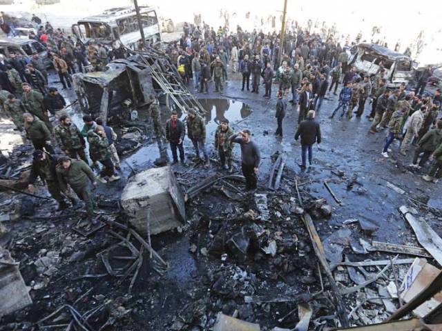 People gather at the site of multiple bombings near the shrine of Bibi Zainab in Damascus