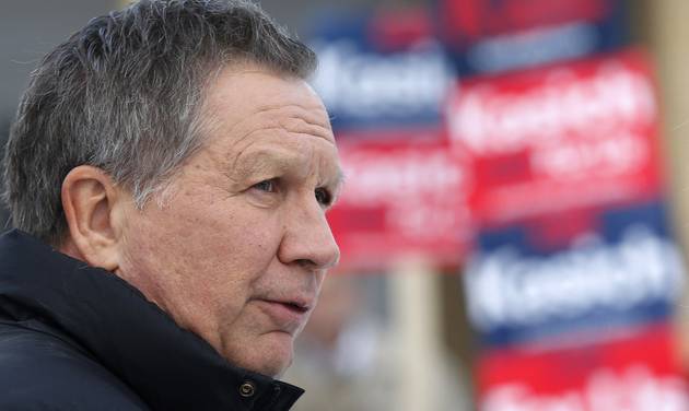 Republican presidential candidate Ohio Gov. John Kasich visits a polling station at the high school Tuesday Feb. 9 2016 in Manchester N.H. as voters cast their ballots for the first in the nation presidential primary