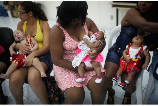 Babies born with microcephaly are held by their mothers at a Carnival party in a health clinic in Recife Brazil on Feb. 4 2016. There should be birth control and abortion options for women in countries seeing a rise in the Zika virus