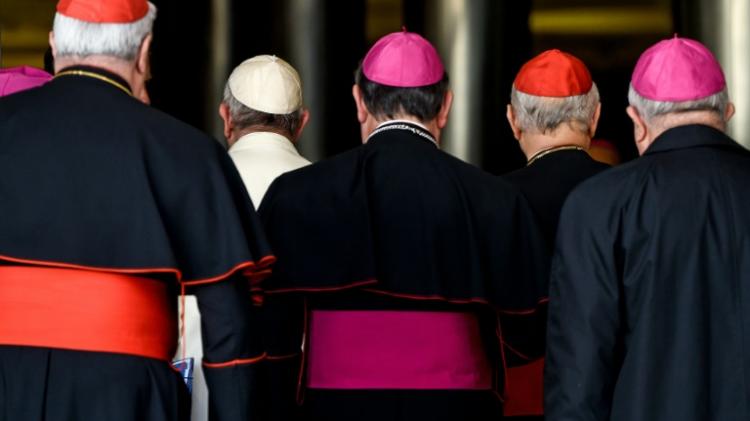 Pope Francis arrives with bishops and cardinals for the morning session on the last day of the Synod on the Family at the Vatican