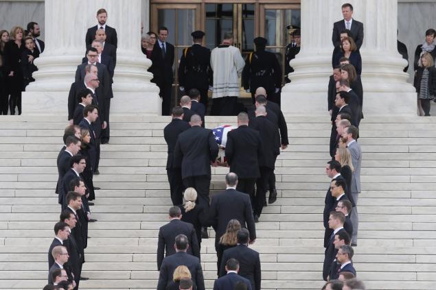 WASHINGTON DC- FEBRUARY 19 One hundred and eighty law clerks line the stairs in front of the U.S. Supreme Court as court police pallbearers carry Associate Justice Antonin Scalia's casket into the court building