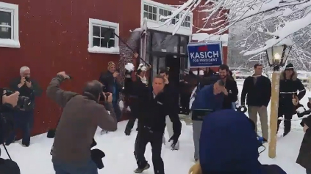 Presidential candidate John Kasich takes part in a snowball fight outside his Hollis N.H. Town Hall event