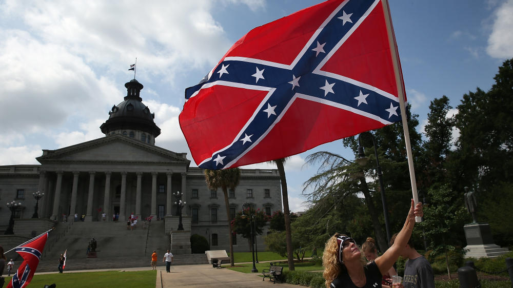 Barbie Byrd of Columbia S.C. joins a group of demonstrators on the grounds of the South Carolina State House calling for the Confederate battle flag to remain on the Capitol grounds in June 2015