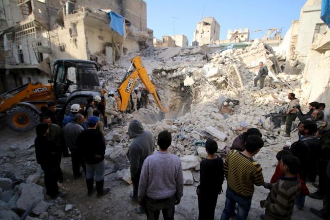 Civil defence members search for survivors after airstrikes by pro Syrian government forces in the rebel held al Qaterji neighbourhood of Aleppo Syria