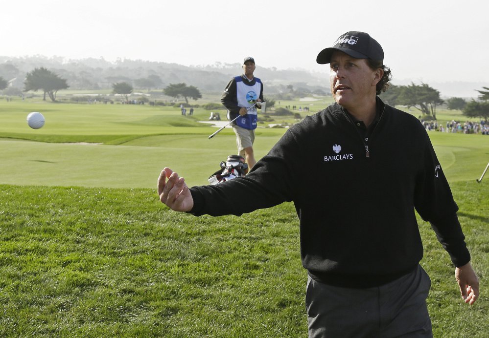 Phil Mickelson tosses his ball to the after putting on the sixth green of the Monterey Peninsula Country Club Shore Course during the second round of the Pebble Beach Pro Am on Friday in Pebble Beach California