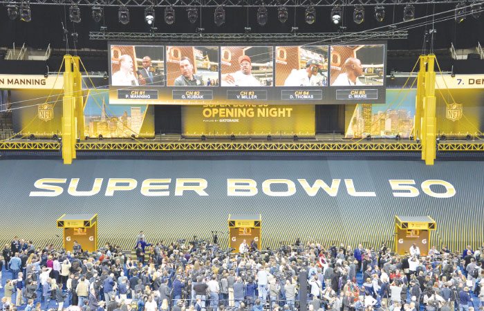 Reporters speak to players during Super Bowl 50 Opening Night media day at SAP Center Monday. — Reuters