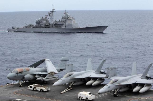 A U.S. Cowpens ship pass during a media tour at the South China Sea