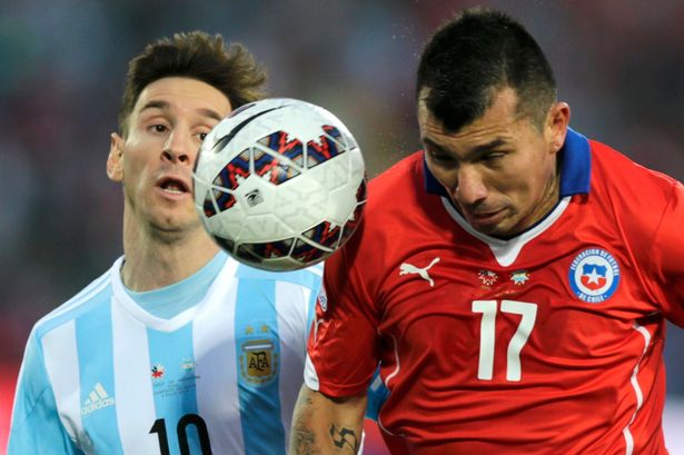 Argentina's Lionel Messi fights for the ball with Chile's Gary Medel