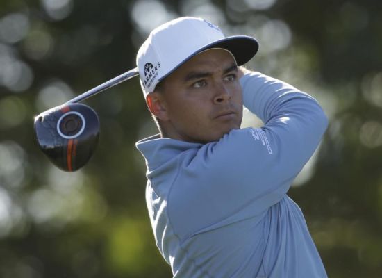 Rickie Fowler watches his tee shot on the