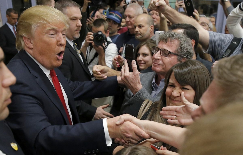 Republican US presidential candidate Donald Trump greets caucus goers as he visits a Nevada Republican caucus site at Palo Verde High School in Las Vegas yesterday. – Reuters pic