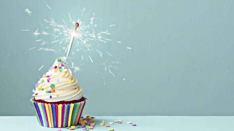 Cupcake decorated with colorful sprinkles and a sparkler