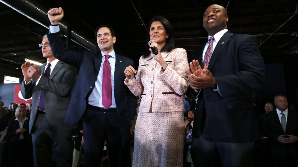 Republican presidential candidate Sen. Marco Rubio R-Fla. raises his arm with Gov. Nikki Haley and Sen. Tim Scott R-S.C. during a town hall Thursday in Greenville S.C