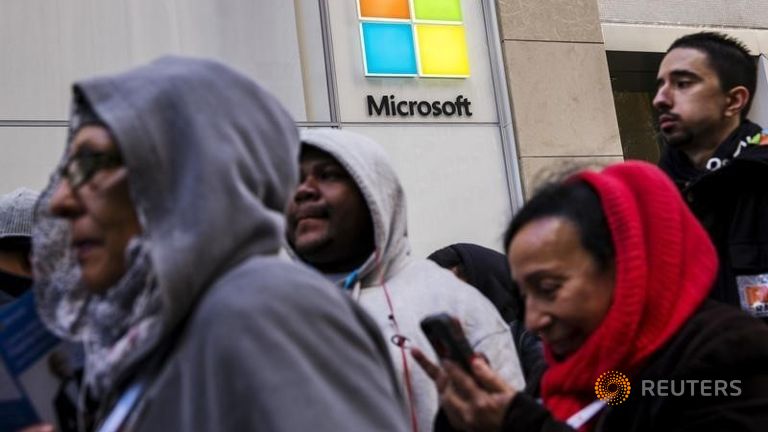 Shoppers stand in line to wait for the grand opening of a flagship Microsoft Corp. retail store in New York