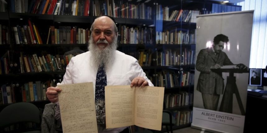 Curator Roni Gross of Hebrew University's Albert Einstein Archive displays original documents related to Einstein's hypothesis on the existence of gravitational waves on Feb. 11 in Jerusalem