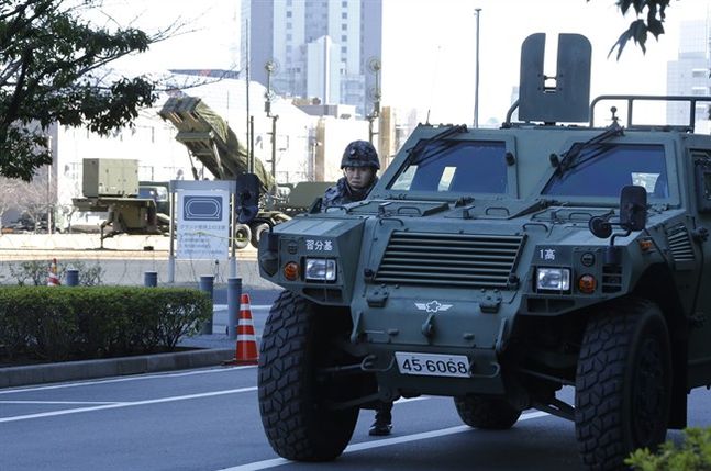 A member of the Japan Self Defense Forces stands near a PAC-3 Patriot missile unit deployed for North Korea's rocket launch at Defense Ministry in Tokyo Sunday Feb. 7 2016. North Korea on Sunday defied international warnings and launched a long-range