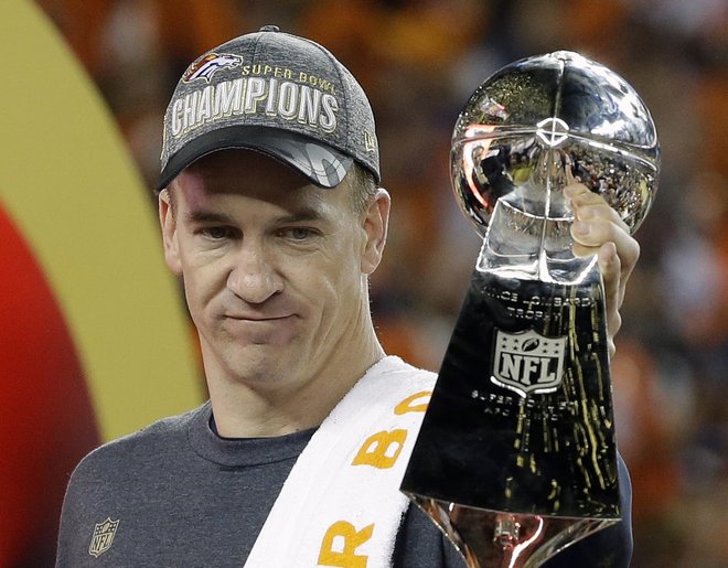 Denver Broncos ™ Peyton Manning holds up the trophy after the NFL Super Bowl 50 football game Sunday Feb. 7 2016 in Santa Clara Calif. The Broncos won 24-10