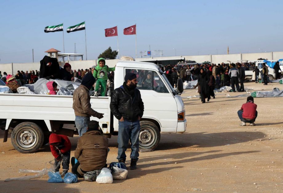 Islamic aid group of IHH Syrians fleeing the conflicts in Azaz region wait at the Bab al Salam border gate Syria Friday Feb. 5 2016. Turkish officials say thousands of Syrians have massed on the Syrian side of the