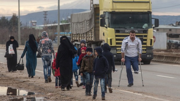 Syrians fleeing a government offensive and Russian airstrikes try to cross the border into Turkey earlier this month