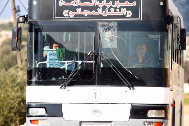 Syrians ride a bus towards Turkey to the Bab Al Salam border crossing in Darat Izza Aleppo countryside Syria