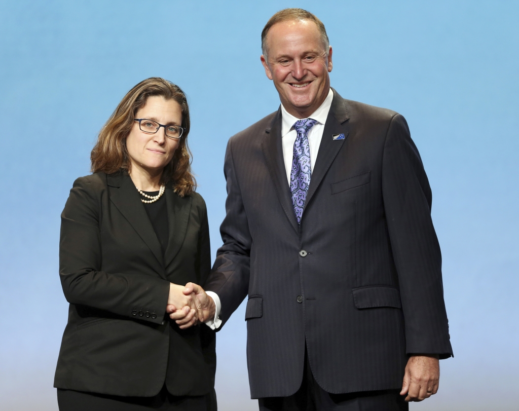 Canadas Minister of International Trade Chrystia Freeland left shakes hands with New Zealand Prime Minister John Key after signing the Trans Pacific Partnership Agreement in Auckland New Zealand Thursday Feb. 4 2016. Trade ministers from 12 Pacifi