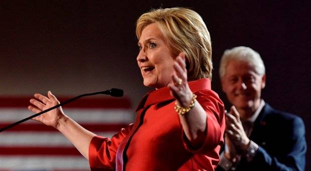 Democratic U.S. presidential candidate Hillary Clinton speaks to supporters as her husband former President Bill Clinton applauds after she was projected to be the winner in the Democratic caucuses in Las Vegas Nevada