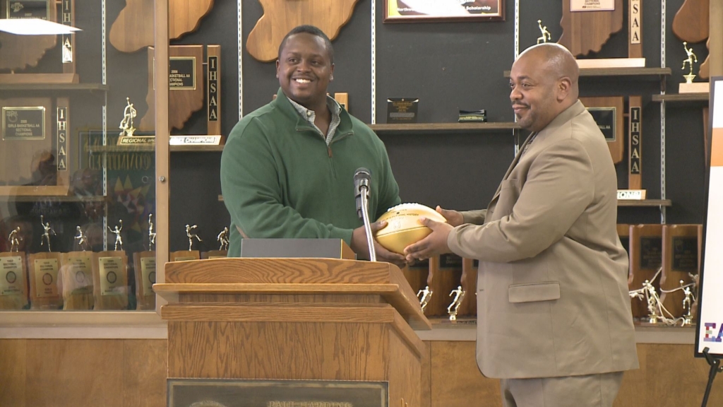 The Two Time Super Bowl champ hands off an NFL golden football to Paul Harding Junior High School