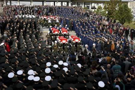 Honour guards carry Turkish flag-draped coffins of car bombing victims during a funeral ceremony at Kocatepe mosque in Ankara Turkey