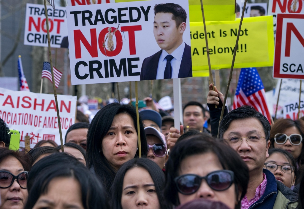 A crowd listens to speakers at a protest rally in the Brooklyn borough of New York Saturday Feb. 20 2016 in support of a former NYPD police officer Peter Liang who was convicted of manslaughter for the 2014 shooting death of Akai Gurley in a housing