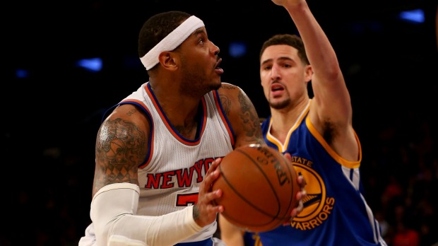 Tight defence Carmelo Anthony heads for the net as Klay Thompson moves