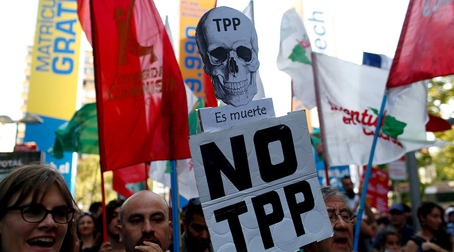 Activists shout slogans during a protest against the TPP and Monsanto Co the world's largest seed company at Santiago Chile