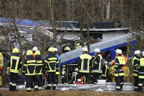 Rescue personnel stand in front of two trains that collided head-on near Bad Aibling southern Germany Tuesday Feb. 9 2016. Several people have been killed and dozens were injured