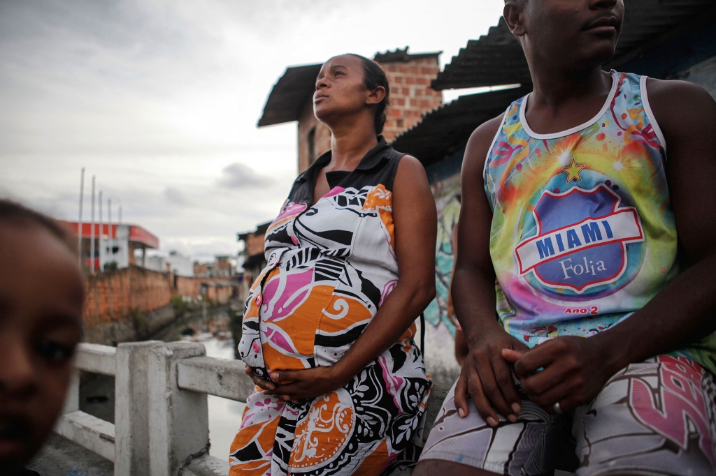 Joana Dark eight months pregnant sits with her husband in their community in Recife Pernambuco state Brazil. Residents said several members of the community were currently sick with mosquito-borne illnesses including the Zika virus