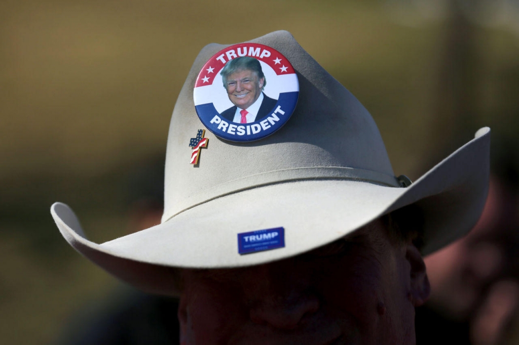 A man waits to see Republican presidential candidate Donald Trump speak to guests during a campaign rally at the Gerald W. Kirn Middle School