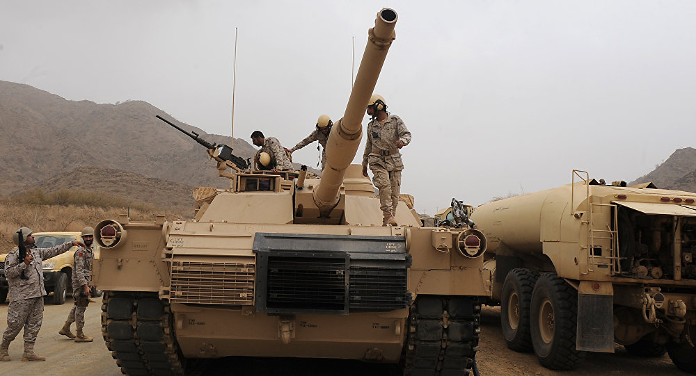 Saudi soldiers are seen on top of their tank deployed at the Saudi Yemeni border in Saudi Arabia's southwestern Jizan province