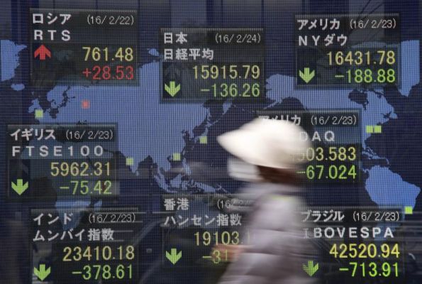 A woman walks past an electronic stock