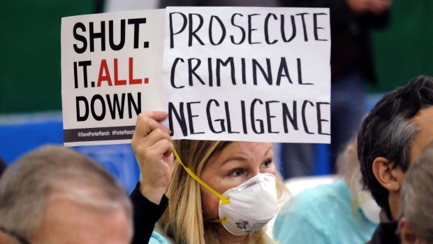 Tera Lecuona resident of the heavily-impacted Porter Ranch area of Los Angeles holds a protest sign during a January hearing in Granada Hills over a gas leak at Southern California Gas Company's Aliso Canyon Storage Facility