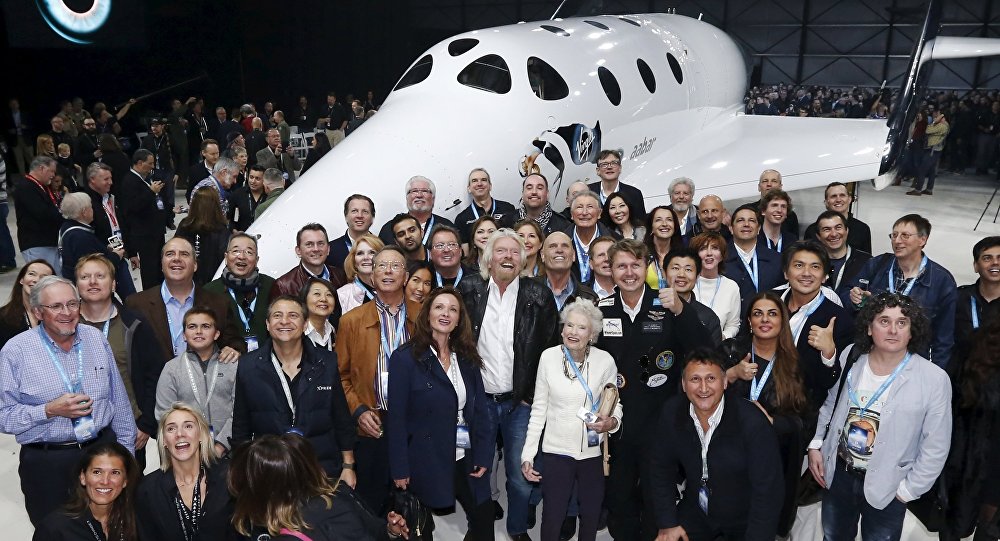 Sir Richard Branson poses with his mother Eve and future astronauts after unveiling the new SpaceShipTwo a six-passenger two-pilot vehicle meant to ferry people into space that replaces a rocket destroyed during a test flight in October 2014