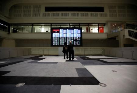 Visitors looks at an electronic board showing the Japan's Nikkei average at the Tokyo Stock Exchange in Tokyo Japan  REUTERS