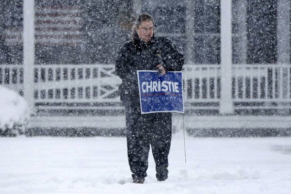 A supporter of Republican presidential candidate Chris Christie leaves a campaign stop during a snowstorm Friday Feb. 5 2016 in Dover N.H