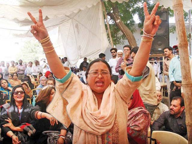 Women shout slogans during a sit-in protest by PIA employees