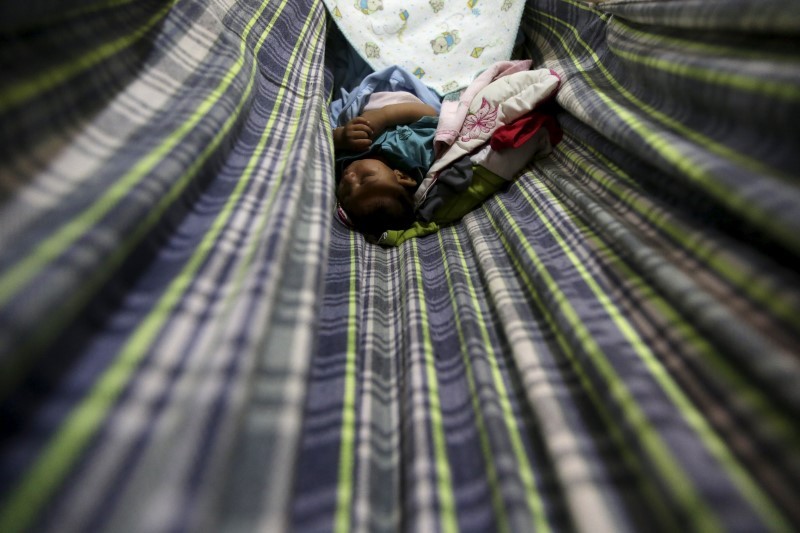 Lucas 4-months old who is Miriam Araujos's second child and born with microcephaly sleeps on a hammock at their house in Sao Jose dos Cordeiros Brazil early