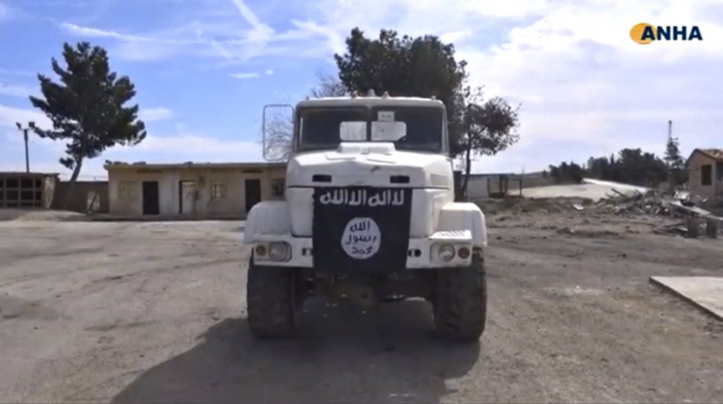 A truck bearing what appears to be Islamic State flag within an oil facility near Al-Shadadi Syria after U.S.-backed alliance captures it from Islamic State following U.S. air strikes is seen in this still image taken from video