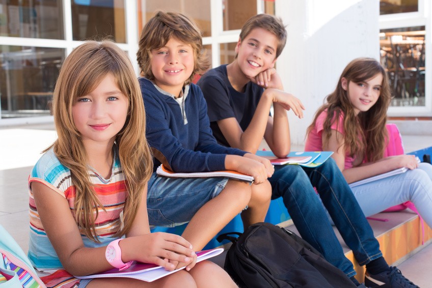 Group of school kids sitting on stairs