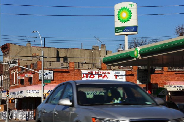 Cars drive by a BP gas station in Brooklyn New York City