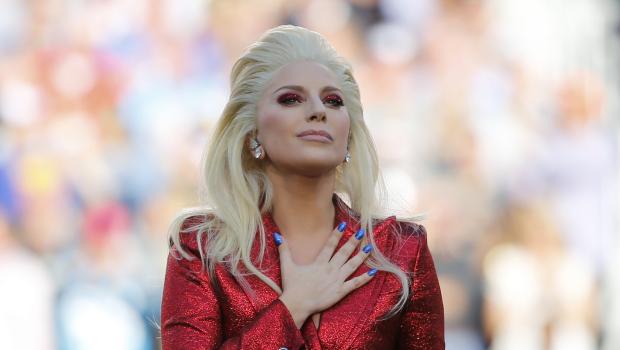 Lady Gaga places her hand over her heart after singing the U.S. National Anthem before the start of the NFL's Super Bowl 50 football game between the Carolina Panthers and the Denver Broncos in Santa Clara California