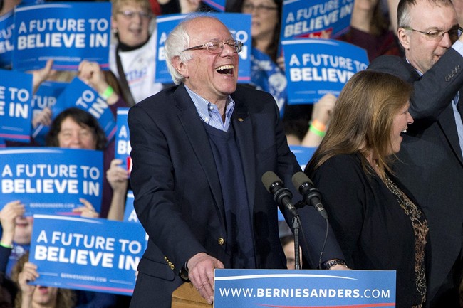 Democratic presidential candidate Sen. Bernie Sanders I-Vt. laughs as he arrives with his wife Jane Sanders and his son Levi Sanders to a primary night rally in Essex Junction Vt. Tuesday