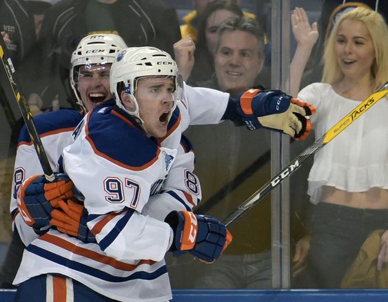 Brandon Davidson left celebrates with center Connor Mc David after Mc David scored in overtime of an NHL hockey game against the Buffalo Sabres Tuesday